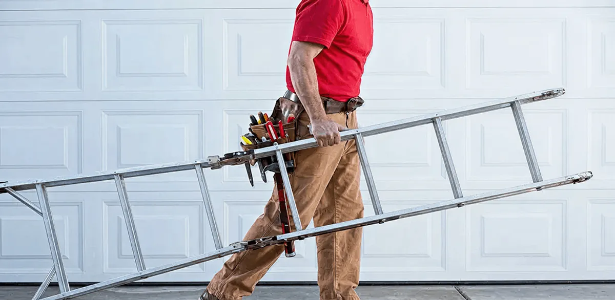 Garage door repair technician arriving with tools and ladder in Columbus, OH