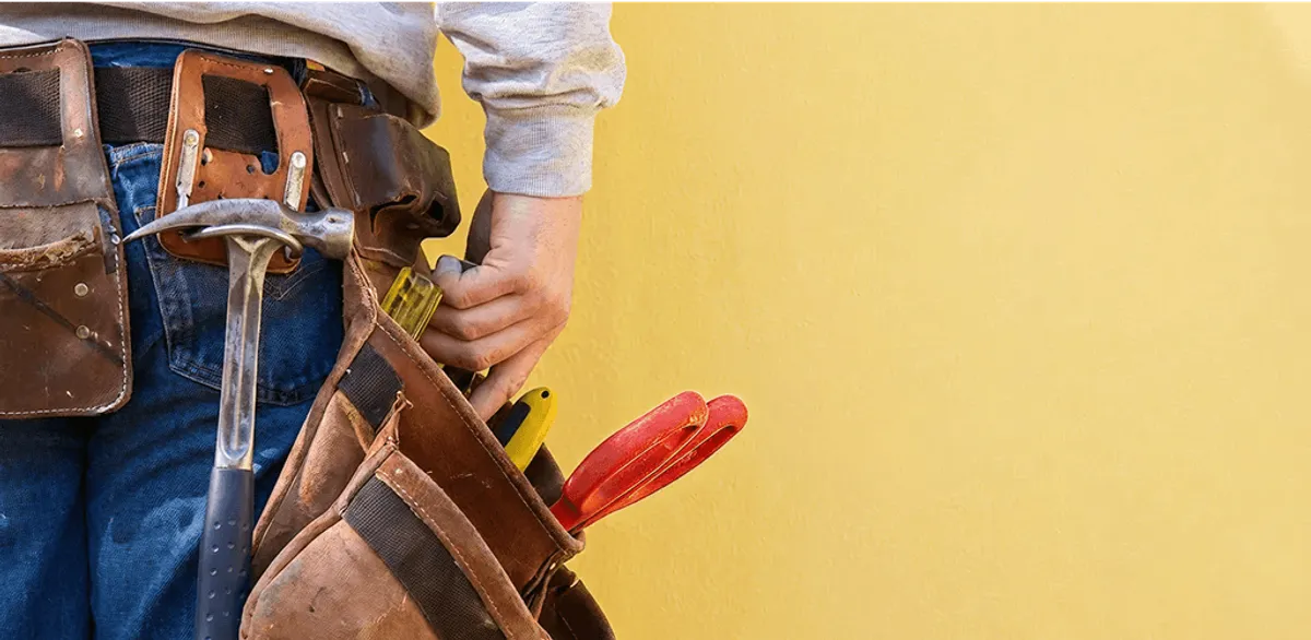 Handyman with tool belt ready for home repairs and maintenance in Columbus, OH