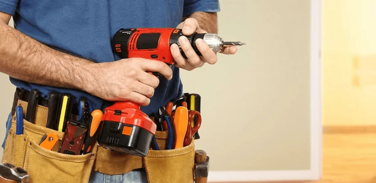 Handyman holding a power drill for home repairs and installations in Columbus, OH